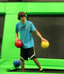 Boy Preparing to Play Dodgeball on a Trampoline